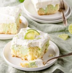 there is a piece of cake with white frosting and limes on the top