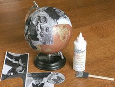 a globe with pictures and glue sitting on top of it next to some other items