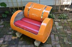 an orange and red chair sitting on top of a brick floor