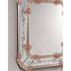 an ornate mirror with pink flowers on it