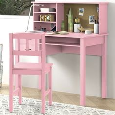 a pink desk and chair in front of a white wall