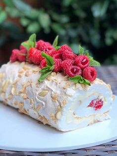 a piece of cake with raspberries on top