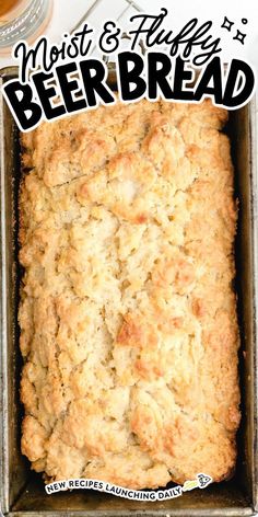 a loaf of beer bread sitting in a pan on top of a white tablecloth