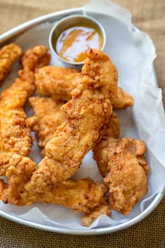 fried chicken sticks with dipping sauce in a bowl