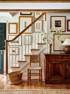 a wooden chair sitting under a stair case