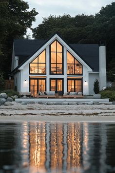 a large white house sitting on top of a lake