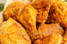 fried chicken pieces in a basket with parsley on the side