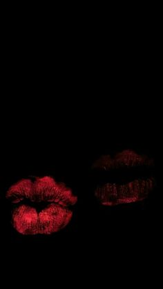 two red lips are lit up in the dark