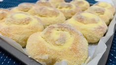 several pastries sitting on top of a pan covered in powdered sugar