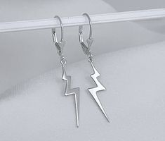 silver bolt earrings,  thunder , celebrity jewelry , silver bolt  ,gold lightening bolt,  celebrity ,  thunder earrings,  silver earrings , bolt  lightning, bolt earrings,  lightning earrings,  silver lightning FEATURE:  Sterling Silver, thunder dangling earring. Approx frame size: 24mm L x 7mm W x 1mm T. . More Meaningful Jewelry: http://www.JewelrywithAMeaning.etsy.com I offer fine jewelry made out of 92.5% Sterling Silver, fine jewelry can last for generations, and it is often considered an investment or something worth collecting and passing down to family members. Rest assure my jewelry does not have allergic metals like nickel or lead. Fashion jewelry is not made of precious metals. ~Thank you for stopping by!! 3 renov 1vent Thunder Earrings, Earrings Lightning, Thunder Necklace, Lightnight Bolt Earrings Big, Lightning Bolt Jewelry, Lightning Bolt Earrings Dangle, Lightning Earrings, Thunder Storm, Bolt Earrings