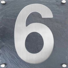 a metal sign with the number six on it