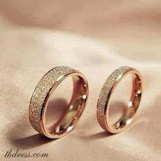 two gold rings with glitter on them