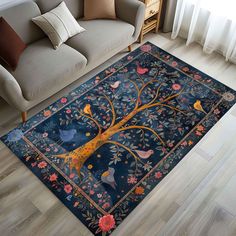 a living room area rug with a tree and birds on the blue background, in front of a couch