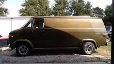 an old van is parked in a parking lot