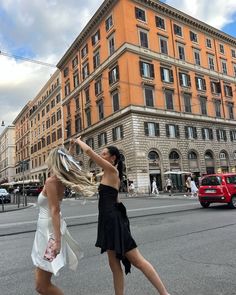 two women are playing tennis on the street