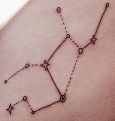 a woman's stomach with a tattoo on it that has the shape of a star