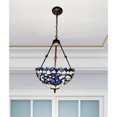 a light fixture hanging from the ceiling in a room with white walls and blue windows