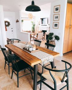 a dining room table with chairs and a rug on the floor