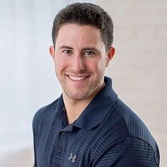 a man in a polo shirt smiling at the camera