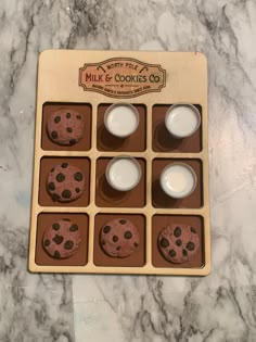 chocolate chip cookies and milk in a box on a marble counter top with a label that says milk & cookies co