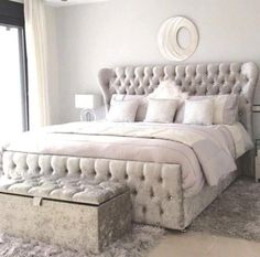 a bedroom with a large bed and white walls