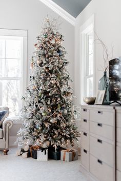 a white christmas tree in a living room