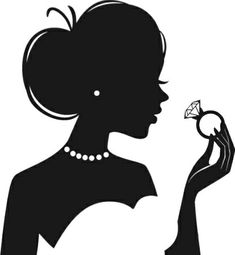 the silhouette of a woman holding a diamond in her hand, and looking at it