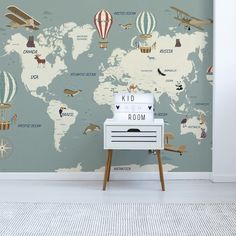 a room with a world map and hot air balloons on the wall