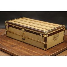 an old trunk sitting on top of a wooden table