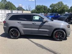 a gray jeep parked in a parking lot