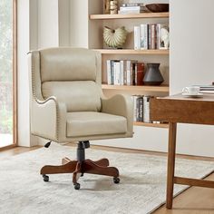 an office chair sitting in front of a book shelf