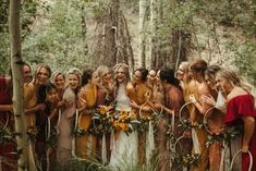 a group of women standing next to each other in the woods