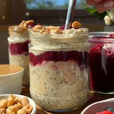 there are three jars with food in them on the table