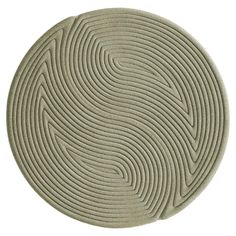 a circular rug with wavy lines on it