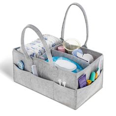 a large gray bag filled with lots of personal care items on top of a white surface