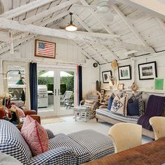 a living room filled with furniture and pictures on the wall