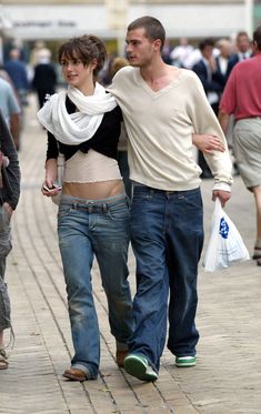 a man and woman walking down the street