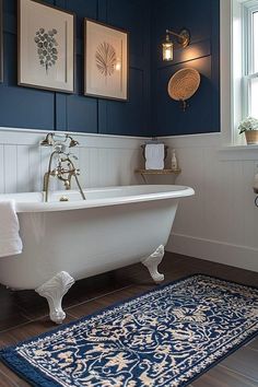 a bath tub sitting next to a window on top of a wooden floor in a bathroom