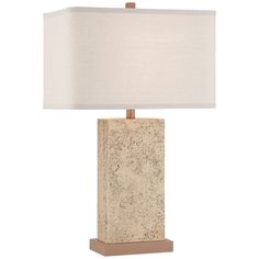 a table lamp with a white shade on it and a wooden base in front of a white background