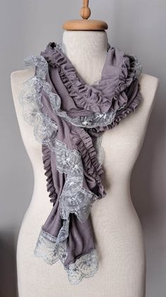 a mannequin wearing a gray scarf