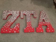 the letters are made out of red and silver glitters, which spell it's 74th birthday