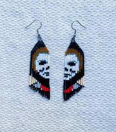 -------- DETAILS: --------  Micheal Myers, Halloween, hand beaded, seed bead, fringe, earrings. The French hook posts are made of hypoallergenic 316L Stainless Steel. These dainty earrings measures 2.5" tall (excluding hook) Very lightweight. ----------------- DELIVERY/SHIPPING ----------------- All earring are made to order.  Care instructions will be included. We pack our jewelry with care to protect the quality of the product. For more information, read the shipping policies. We are not respo Halloween Beaded Jewelry, Seed Bead Fringe Earrings, Hand Beaded Earrings, Bead Fringe Earrings, Seed Bead Crafts, Beads Craft Jewelry, Holiday Beading, Bead Fringe, Beadwork Designs