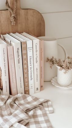 a stack of books sitting on top of a white table