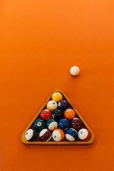 billiard balls in a triangle on an orange background