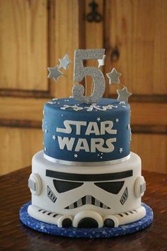 a star wars themed birthday cake with the number five on it's top tier