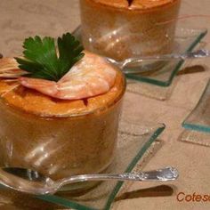 two glasses filled with food sitting on top of a table