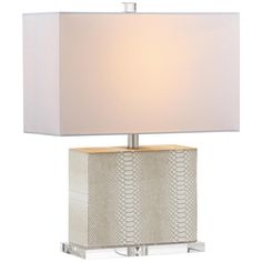 a table lamp with a white shade on the base and a silver metal frame around it