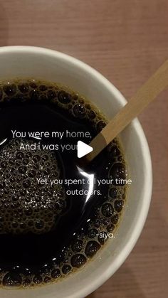 a cup of coffee with a spoon in it and an ad on the side that says, you were my home and i was you