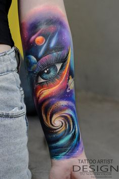 a woman's arm with an eye tattoo on it