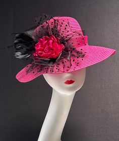 The featured hat is a fuchsia  straw hat with a black crinoline flower, black netting, black feathers and a fuchsia center fabric flower. This hat is so eye popping and gorgeous  it's a must have for any woman who loves hats. This  hat is a beautiful church hat or a Kentucky Derby Hat.  Also perfect  for an Easter Hat, Tea Party hat,Wedding Party Hat, Fancy Dress Hat , Downton Abby hat and any other special occasion. Brim:   3" Rise:   4" Size:   22" Pink Fedora Sun Hat For Party, Pink Party Hat With Flat Brim, Pink Flat Brim Party Hat, Mini Fedora Hats For Kentucky Derby Garden Party, Fedora Mini Hats For Kentucky Derby Garden Party, Pink Flat Brim Sun Hat For Party, Pink Fedora Sun Hat For Kentucky Derby, Pink Brimmed Costume Hats For Party, Pink Fedora Straw Hat For Kentucky Derby